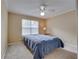 Cozy bedroom featuring neutral paint, a lighted ceiling fan, and plush carpeting at 330 Teal Ct, Roswell, GA 30076