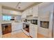 Bright kitchen with white cabinets, stainless steel appliances, and hardwood floors at 330 Teal Ct, Roswell, GA 30076