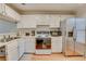 White kitchen features ample cabinet space and stainless steel appliances at 330 Teal Ct, Roswell, GA 30076