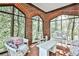 Bright sunroom with brick walls, floor and abundant windows for a tranquil indoor-outdoor experience at 3555 Kingsboro Ne Rd, Atlanta, GA 30319