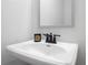 Bathroom with a single sink vanity, a large mirror, and modern black fixtures at 508 Red Terrace, Marietta, GA 30060