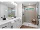 Modern bathroom featuring a tiled shower with a glass enclosure, double sinks and updated fixtures at 508 Red Terrace, Marietta, GA 30060