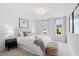 Bright bedroom with plush carpet, neutral tones, large windows, and a decorative woven bench at the foot of the bed at 508 Red Terrace, Marietta, GA 30060