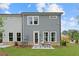 Rear exterior of a gray townhome with a patio, table, chairs, and green lawn at 508 Red Terrace, Marietta, GA 30060