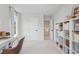 Bright room featuring a white desk and chair, a shelf, a large window, and neutral decor at 508 Red Terrace, Marietta, GA 30060
