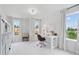 Bright room featuring a white desk and chair, a shelf, two large windows, and neutral decor at 508 Red Terrace, Marietta, GA 30060