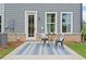 Backyard patio with a table and chairs, brick trim, blue rug and gray siding at 508 Red Terrace, Marietta, GA 30060