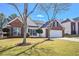 Charming single-Gathering home featuring a well-manicured lawn, brick accents, and a two-car garage at 744 Mesa Rd, Mcdonough, GA 30253