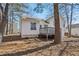 The back of the home has a deck and stairs leading to the ground at 155 Hitchcock Dr, Villa Rica, GA 30180