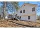 The back of the home has a deck and stairs leading to the ground at 155 Hitchcock Dr, Villa Rica, GA 30180
