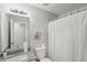 A bathroom featuring granite countertop, framed mirror, white shower curtain, and white fixtures at 155 Hitchcock Dr, Villa Rica, GA 30180