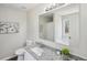 A bathroom featuring granite countertop, large framed mirror, white shower curtain, and modern fixtures at 155 Hitchcock Dr, Villa Rica, GA 30180