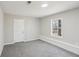 Cozy bedroom featuring plush carpeting, a window providing natural light, and convenient access to a closet at 155 Hitchcock Dr, Villa Rica, GA 30180