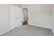 An empty bedroom features light gray walls, neutral carpet, and a closet with double doors at 155 Hitchcock Dr, Villa Rica, GA 30180
