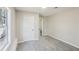 An empty bedroom features light gray walls, neutral carpet, a window, and a white door at 155 Hitchcock Dr, Villa Rica, GA 30180
