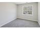 A bedroom featuring light gray walls, neutral carpet, and a window with natural light at 155 Hitchcock Dr, Villa Rica, GA 30180