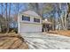 Two-story home with a two-car garage and an inviting front porch and steps at 155 Hitchcock Dr, Villa Rica, GA 30180