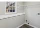 Functional laundry area with shelving and a window, maximizing space and convenience for household chores at 155 Hitchcock Dr, Villa Rica, GA 30180