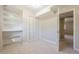 Bedroom featuring carpeting, closet with louvered doors, and built in storage at 2330 Regal Ct, Lawrenceville, GA 30044