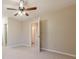 Cozy bedroom featuring neutral carpeting and a ceiling fan at 2330 Regal Ct, Lawrenceville, GA 30044