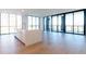 Spacious kitchen with island, hardwood floors, floor to ceiling windows, and a balcony entrance at 2425 Peachtree Ne Rd # 1104, Atlanta, GA 30305
