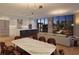 Open concept kitchen and living room with modern lighting, dining table, and floor to ceiling windows at 2425 Peachtree Ne Rd # 1104, Atlanta, GA 30305