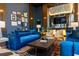 Lobby seating area with contemporary furniture, blue couches, decorative rugs, and artwork at 2425 Peachtree Ne Rd # 1104, Atlanta, GA 30305