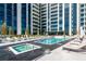 Relaxing outdoor pool and hot tub area with lounge chairs and views of the building at 2425 Peachtree Ne Rd # 1104, Atlanta, GA 30305