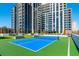 Outdoor tennis court next to the high-rise with manicured landscaping at 2425 Peachtree Ne Rd # 1104, Atlanta, GA 30305