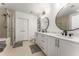 Elegant bathroom with double vanity, marble countertops, modern fixtures, and a glass-enclosed shower at 1080 Peachtree Ne St # 1909, Atlanta, GA 30309