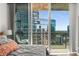 This bedroom offers a serene retreat with a large window showcasing an amazing cityscape view at 1080 Peachtree Ne St # 1909, Atlanta, GA 30309