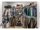 This large walk-in closet offers ample storage with rods, shelves, and a light wood floor at 1080 Peachtree Ne St # 1909, Atlanta, GA 30309