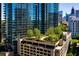 Stunning glass high-rise building featuring a rooftop pool and lush garden area at 1080 Peachtree Ne St # 1909, Atlanta, GA 30309