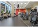 Well-equipped gym featuring cardio and weight machines, with large windows and a TV at 1080 Peachtree Ne St # 1909, Atlanta, GA 30309