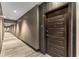 Modern apartment hallway featuring wood-look flooring, stylish wallpaper and multiple recessed lights at 1080 Peachtree Ne St # 1909, Atlanta, GA 30309