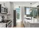 Bright kitchen with white cabinetry, stainless appliances, large island, and city views at 1080 Peachtree Ne St # 1909, Atlanta, GA 30309