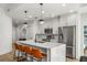 Modern kitchen featuring stainless steel appliances, a large island with seating, and sleek white cabinetry at 1080 Peachtree Ne St # 1909, Atlanta, GA 30309