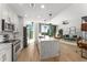 Open-concept kitchen with stainless steel appliances and quartz countertop island leading to the living space at 1080 Peachtree Ne St # 1909, Atlanta, GA 30309