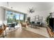 Inviting living room with stylish furniture, hardwood floors, and a stunning city view from the large window at 1080 Peachtree Ne St # 1909, Atlanta, GA 30309