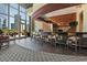 Modern lounge area with bar seating, dark wood flooring, and large windows with city views at 1080 Peachtree Ne St # 1909, Atlanta, GA 30309
