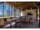 Outdoor kitchen area with a grill and bar seating, with a view of a nearby building at 1080 Peachtree Ne St # 1909, Atlanta, GA 30309