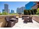 Relaxing patio with wicker furniture and city views, perfect for outdoor lounging at 1080 Peachtree Ne St # 1909, Atlanta, GA 30309