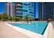 Beautiful pool with surrounding lounge chairs and high rise buildings in the background at 1080 Peachtree Ne St # 1909, Atlanta, GA 30309