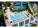 Rooftop pool area with many lounge chairs, umbrellas, and city views in this aerial image at 1080 Peachtree Ne St # 1909, Atlanta, GA 30309