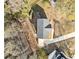 Overhead aerial shot of a home with a gray roof, long driveway, and wooded surroundings at 122 S Mill Creek Ct, Woodstock, GA 30188
