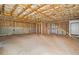 Unfinished basement area featuring concrete floors, exposed ceiling beams, and framing at 122 S Mill Creek Ct, Woodstock, GA 30188