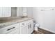 Bathroom vanity with granite countertops and white cabinets at 122 S Mill Creek Ct, Woodstock, GA 30188
