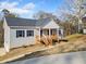 Charming single story home with gray siding, blue shutters and wood porch at 122 S Mill Creek Ct, Woodstock, GA 30188