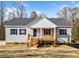 Charming single story home with gray siding, blue shutters and wood porch at 122 S Mill Creek Ct, Woodstock, GA 30188