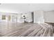 Bright, open-concept living space featuring hardwood floors and a modern kitchen with white cabinets at 122 S Mill Creek Ct, Woodstock, GA 30188